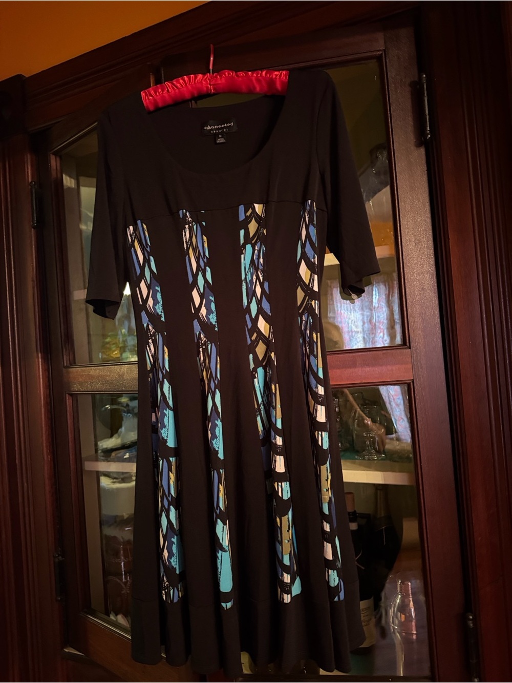 connected apparel Black Dress with stained glass looking colorful panels.